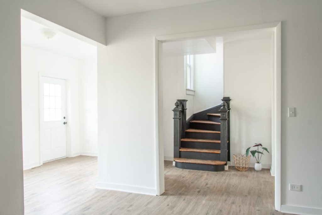 Services a-white-room-with-a-staircase-and-a-potted-plant-srxk8ep6olo